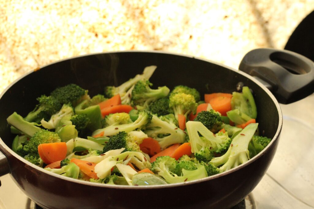 Vegetarian Recipes: Close-up of vibrant stir-fried vegetables in a pan, perfect for healthy cooking.